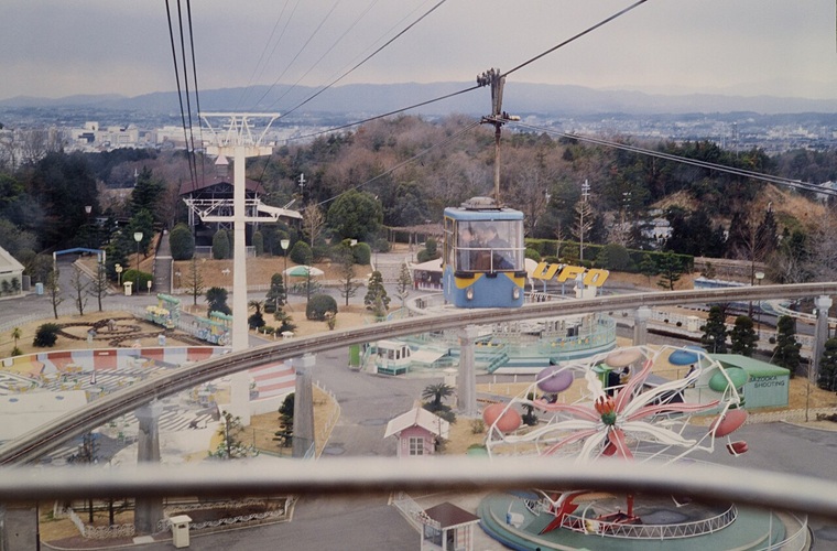 The Aska wooden roller coaster at Nara Dreamland, Japan's abandoned theme park, rising above the overgrowth.