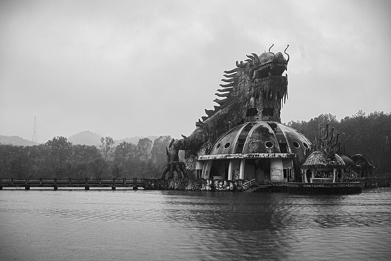 The giant concrete dragon at Ho Thuy Tien abandoned water park near Hue, Vietnam, rising over the lake.