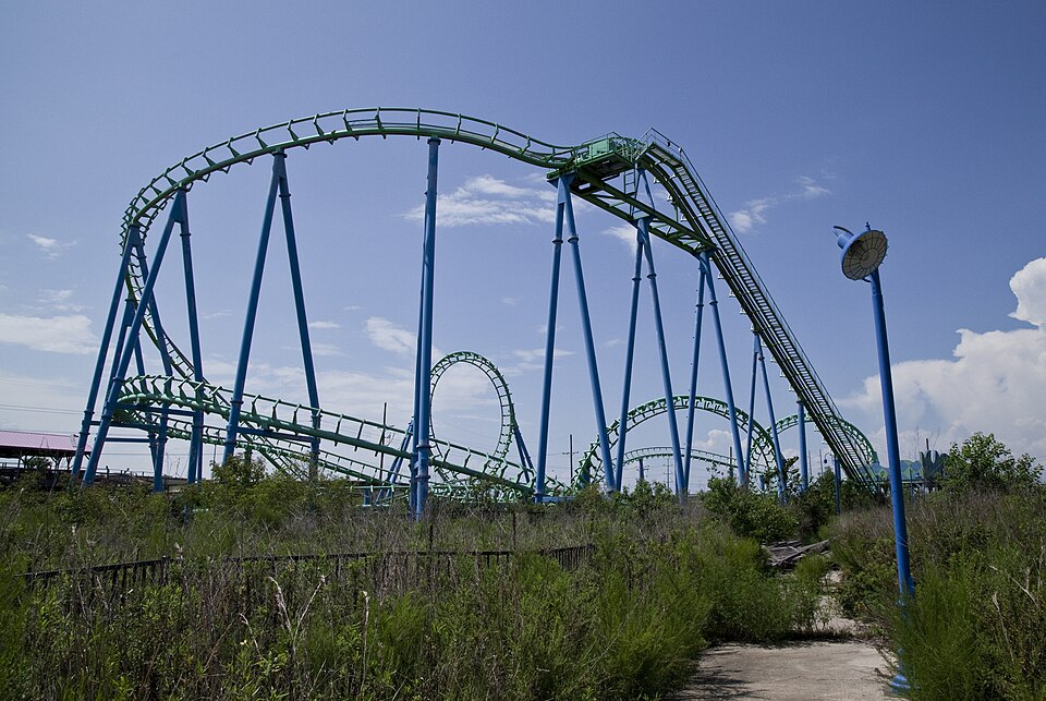 Overgrown, rusted rides inside the abandoned Six Flags New Orleans, reclaimed by swamp and wildlife